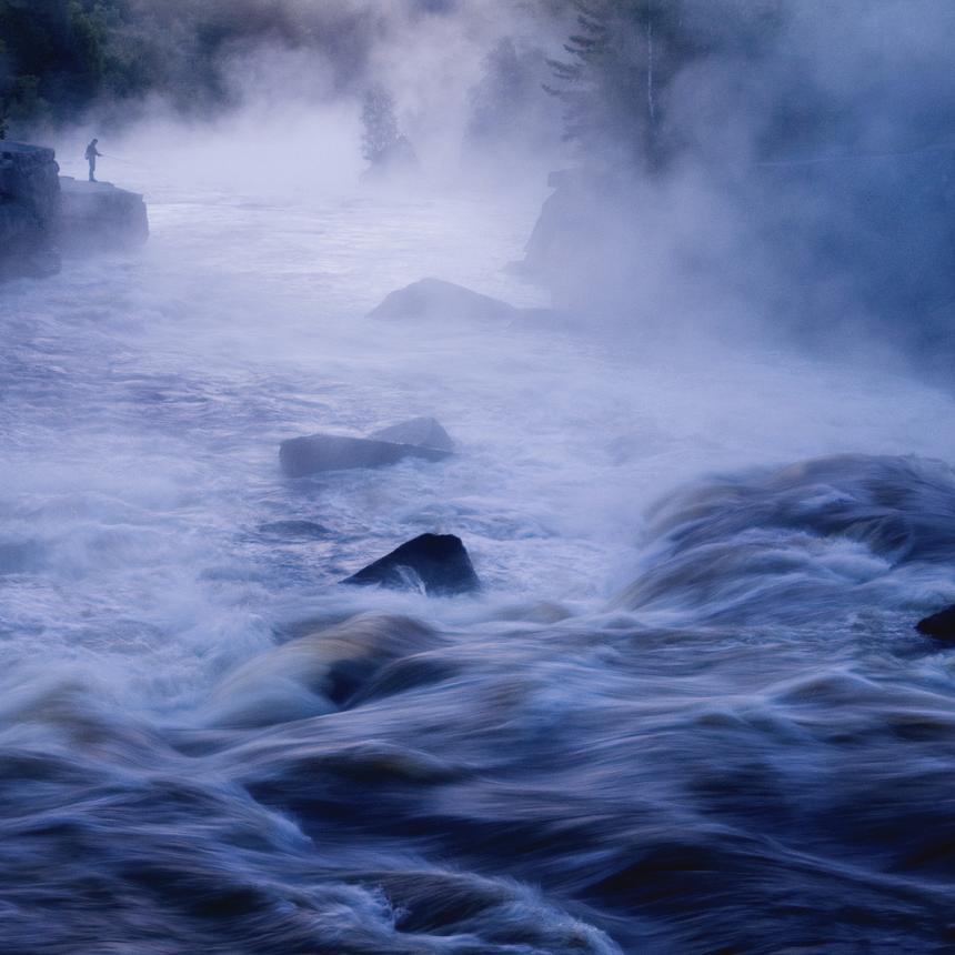 Raging river water crashing on rocks