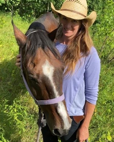 A photo of Kristen with a horse