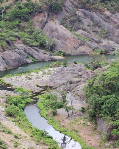 Aerial view of creek running through rocks